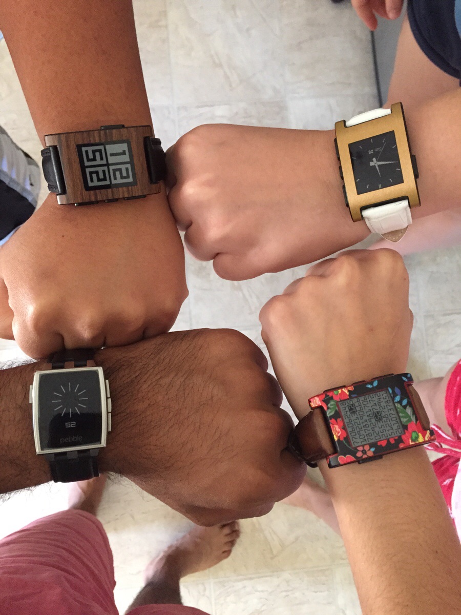 4 wrists showing Pebble smartwatches